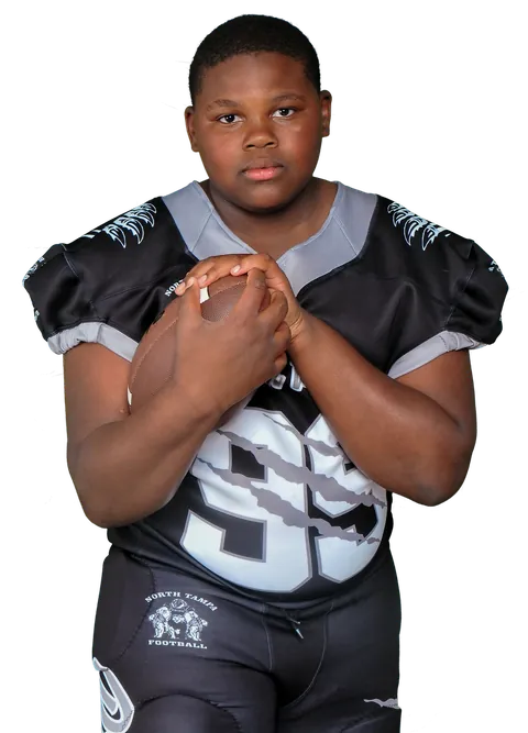 North Tampa Pride football player holding a football